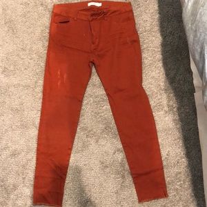 Lightly distressed orange skinny jeans